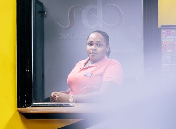 CBN employee in St. Lucia at a lottery terminal